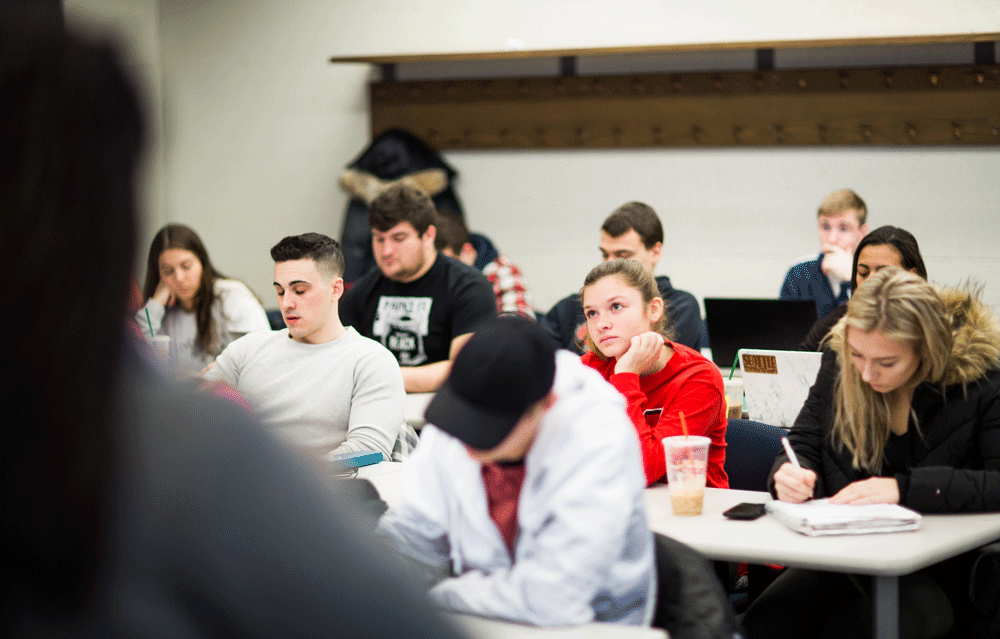 Students listening to a lecture at the Barney School of Business